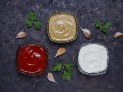 Homemade ketchup,mustard and mayonnaise sauce and ingredients on