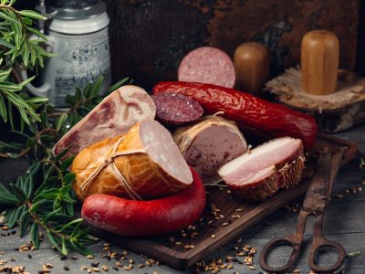 sausage assortment salami, pepperoni, ham on wooden board